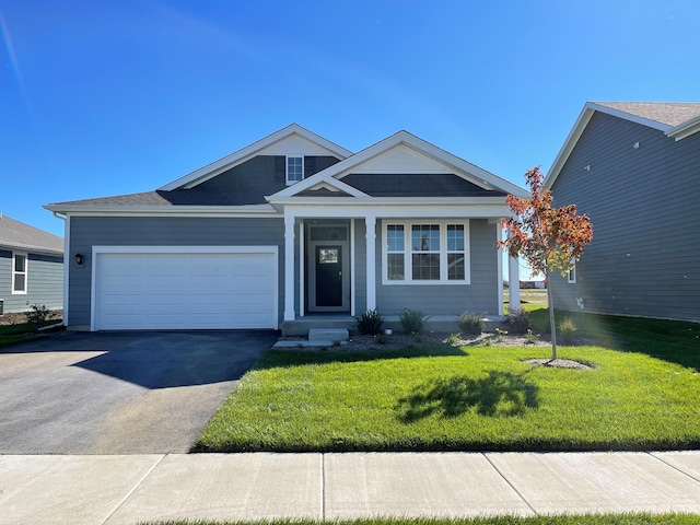 view of front of home featuring a garage and a front lawn