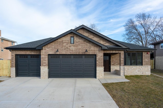 view of front of property with a garage and a front lawn