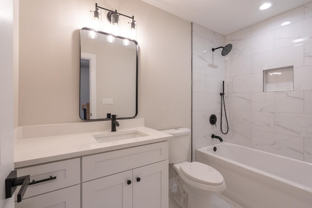 full bathroom with vanity, tiled shower / bath combo, and toilet