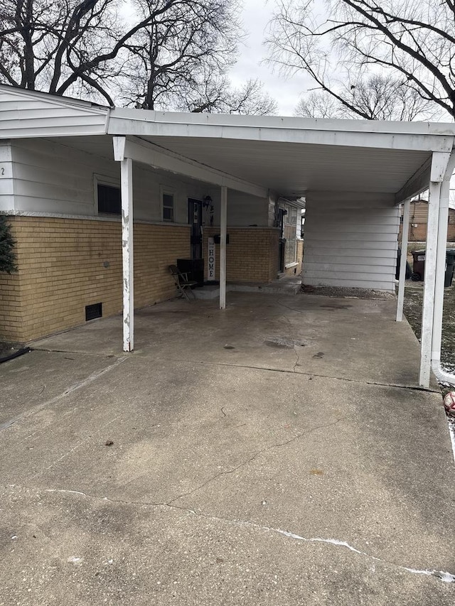 view of vehicle parking with a carport