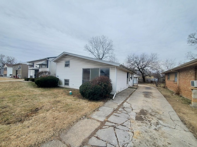 view of property exterior featuring a lawn