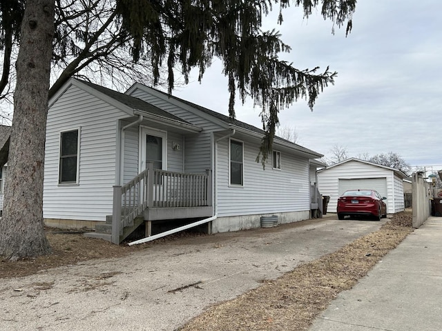 view of front of house with a garage and an outdoor structure