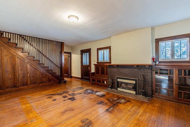 unfurnished living room with hardwood / wood-style flooring and a fireplace