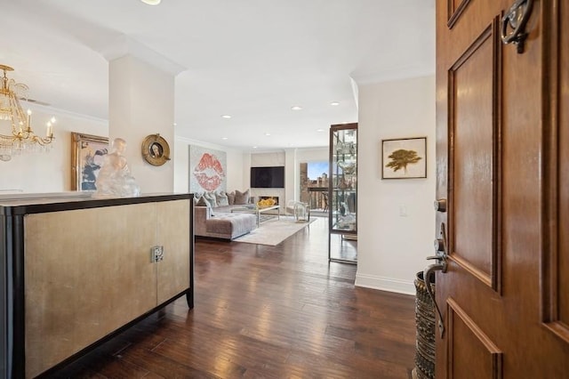 entryway with crown molding, baseboards, an inviting chandelier, recessed lighting, and dark wood-type flooring