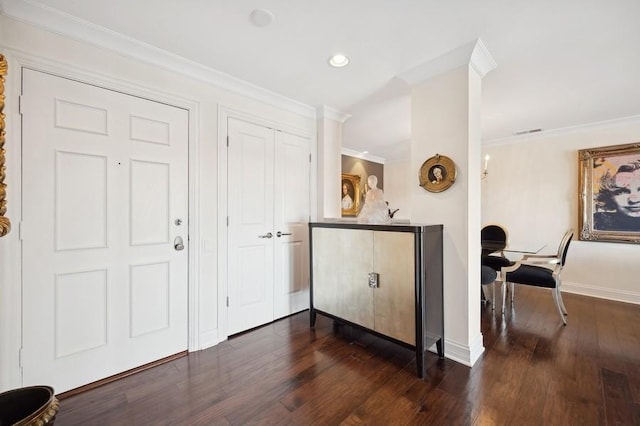 entryway with ornamental molding, baseboards, visible vents, dark wood-style floors, and recessed lighting