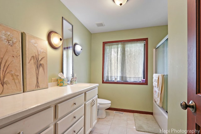 full bath with vanity, toilet, tile patterned floors, baseboards, and combined bath / shower with glass door