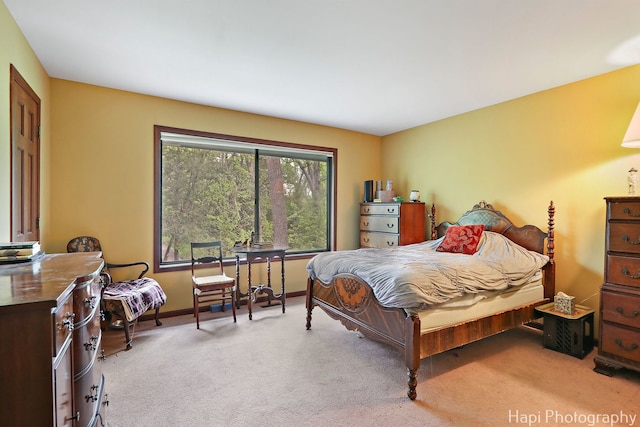 carpeted bedroom featuring baseboards