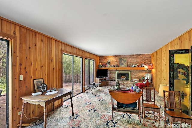 living area featuring wooden walls and a fireplace