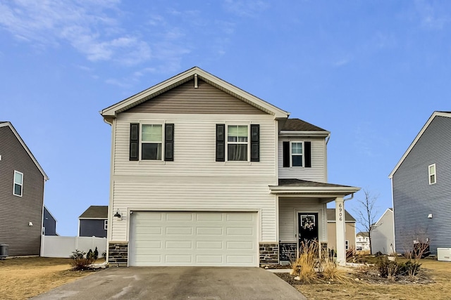 view of front property featuring a garage and central AC unit