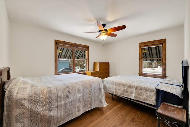 bedroom with dark wood-type flooring and ceiling fan