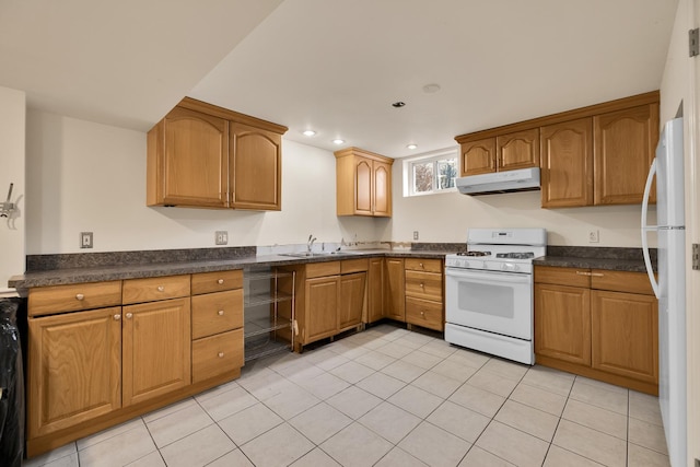 kitchen featuring sink, light tile patterned floors, and white appliances