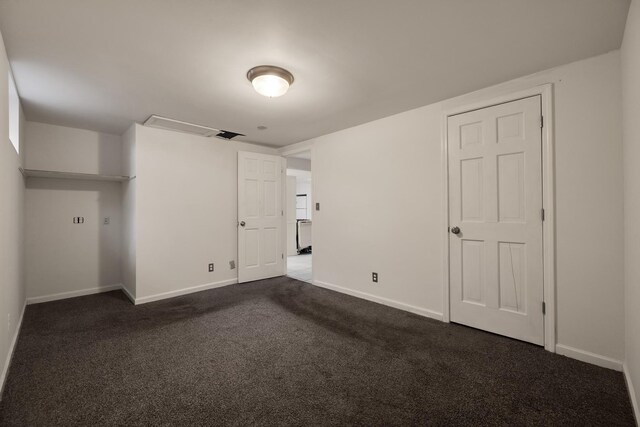 spare room with dark colored carpet