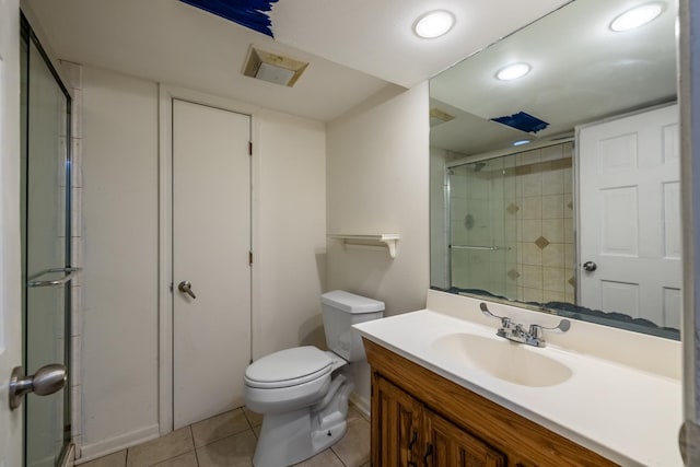 bathroom with vanity, a shower with shower door, tile patterned floors, and toilet