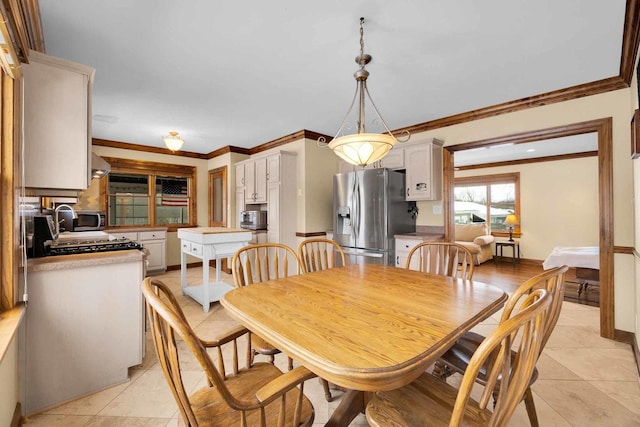 dining area featuring crown molding and light tile patterned flooring