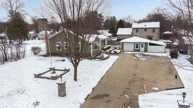 snowy yard with a garage