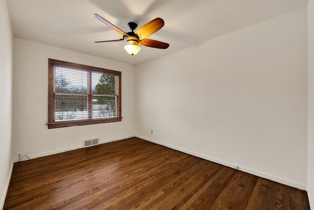 empty room with dark wood-type flooring and ceiling fan