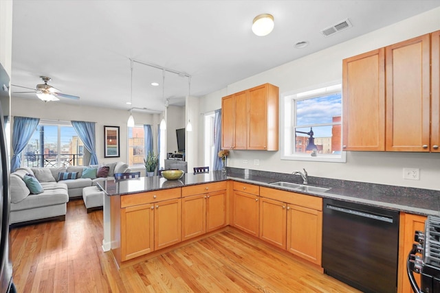 kitchen with dishwasher, light wood-style flooring, open floor plan, a peninsula, and a sink