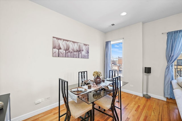 dining area featuring light wood-type flooring, baseboards, visible vents, and recessed lighting