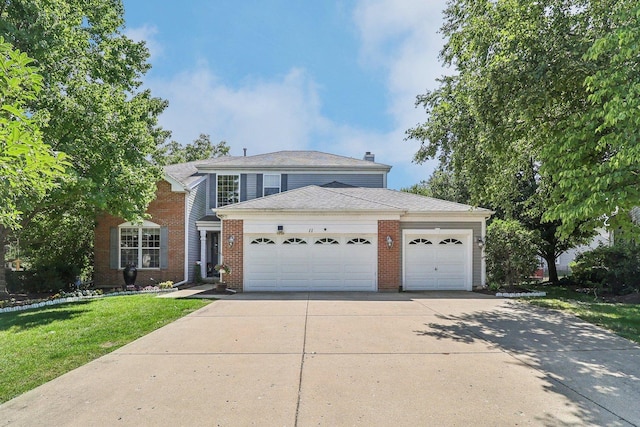 view of front of property with a garage and a front lawn