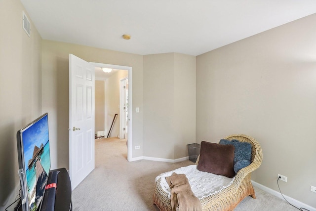 sitting room featuring light colored carpet