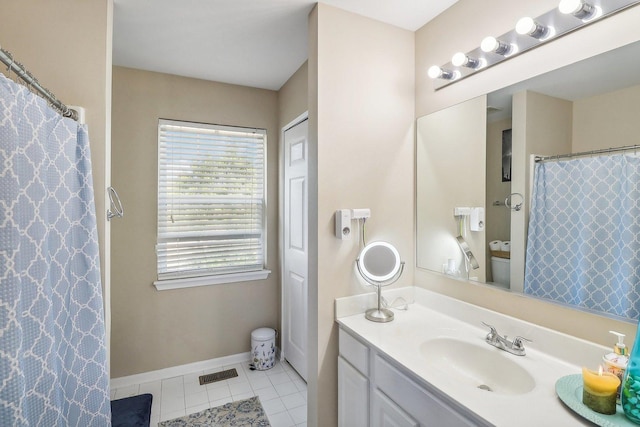 bathroom with vanity, toilet, and tile patterned flooring