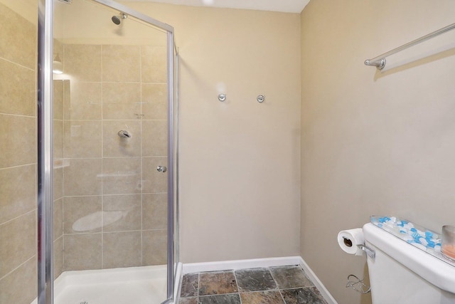 bathroom with toilet and an enclosed shower