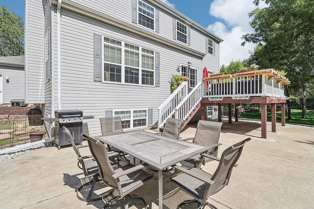 view of patio / terrace featuring a wooden deck and grilling area