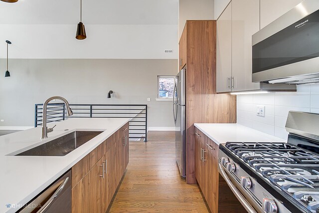 1734 W Cullerton St, Chicago, IL 60608 - kitchen with sink, white cabinets, hanging light fixtures, light hardwood / wood-style floors, and stainless steel appliances