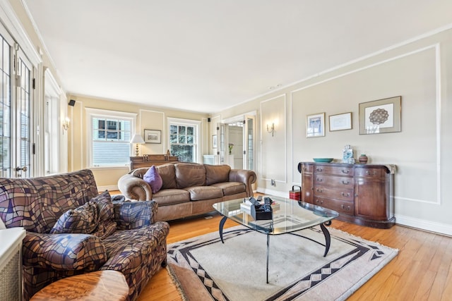 living room with light wood-style flooring and baseboards