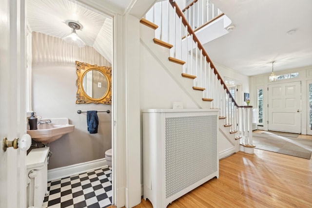 entrance foyer featuring stairs and baseboards