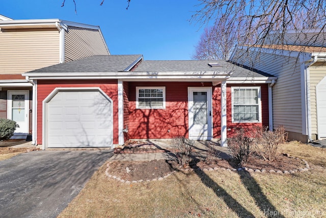 view of front of house with a garage and a front lawn