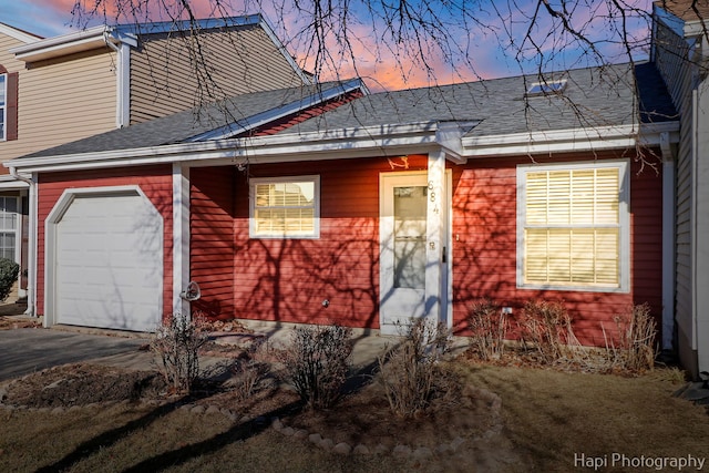 property exterior at dusk featuring a garage