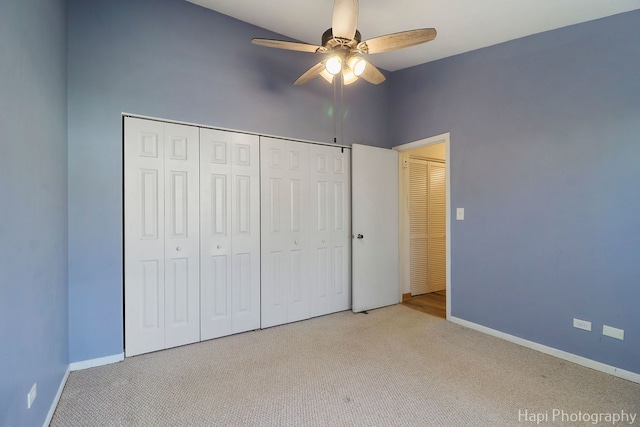 unfurnished bedroom with ceiling fan, a closet, and light carpet