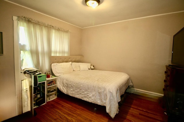 bedroom featuring baseboards and wood finished floors