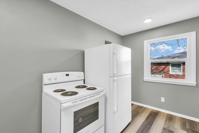 kitchen with white appliances and wood-type flooring