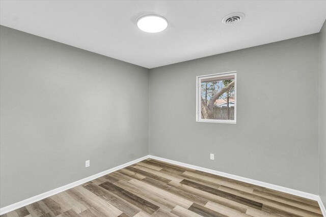 unfurnished room with hardwood / wood-style floors