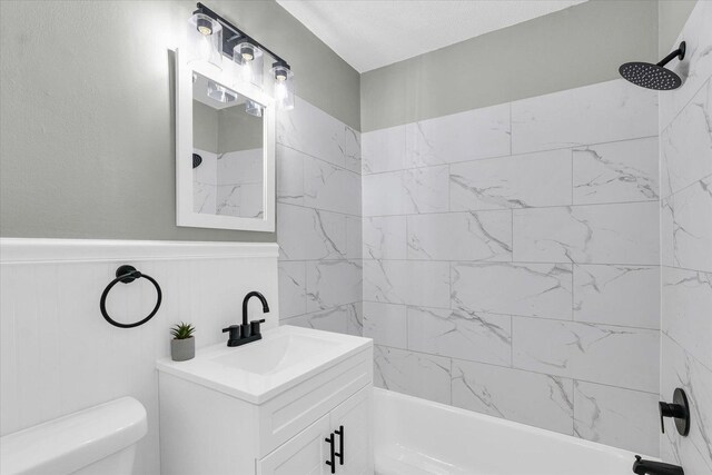 full bathroom featuring vanity, toilet, and tiled shower / bath combo