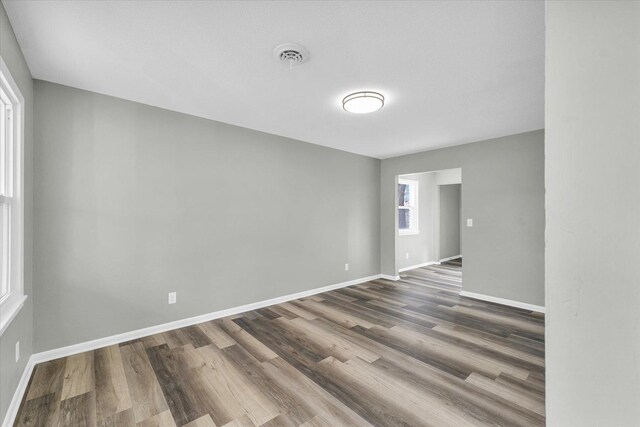 unfurnished room with dark hardwood / wood-style floors