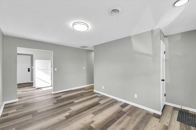 empty room featuring hardwood / wood-style flooring