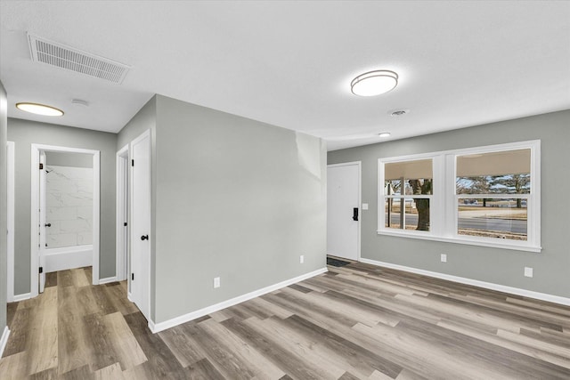 empty room with hardwood / wood-style floors