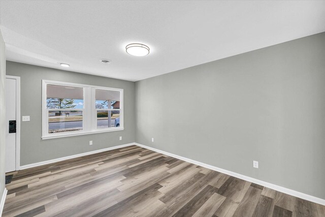 spare room featuring hardwood / wood-style floors