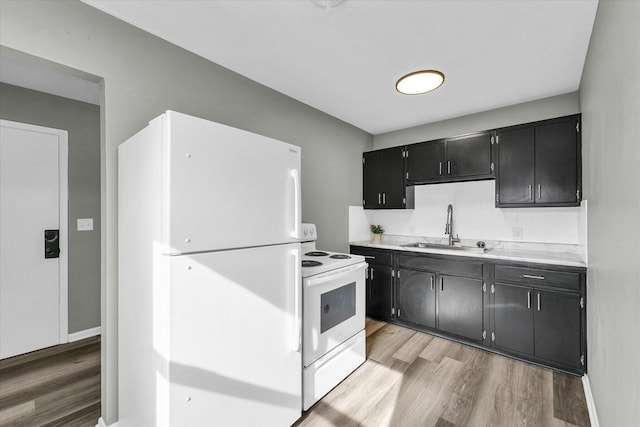 kitchen with sink, decorative backsplash, white appliances, and light hardwood / wood-style flooring