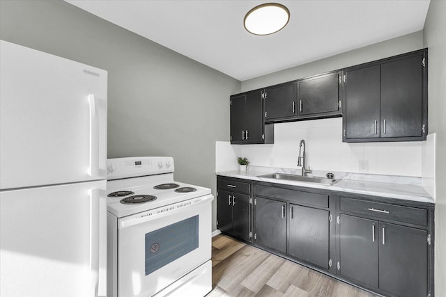 kitchen with tasteful backsplash, sink, white appliances, and light hardwood / wood-style flooring