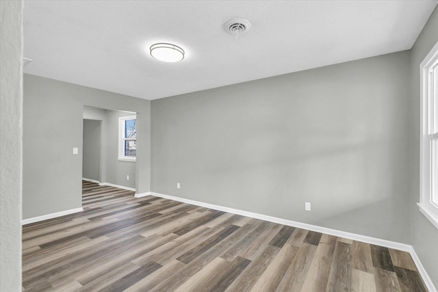 empty room featuring hardwood / wood-style floors and a textured ceiling