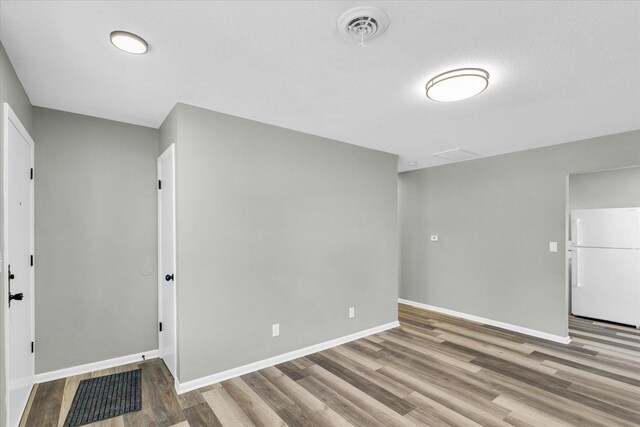 interior space with hardwood / wood-style flooring and a textured ceiling
