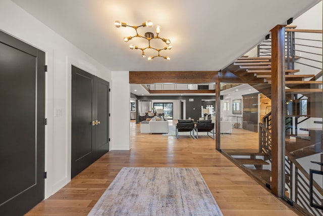 entrance foyer with stairs, baseboards, and wood finished floors