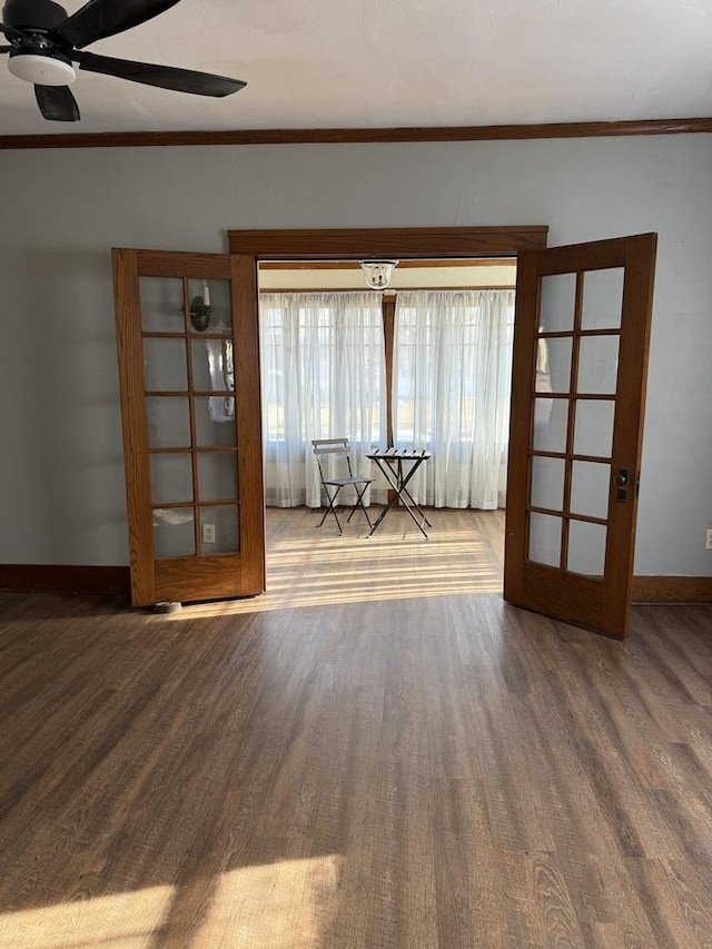 spare room featuring wood-type flooring, ornamental molding, and ceiling fan