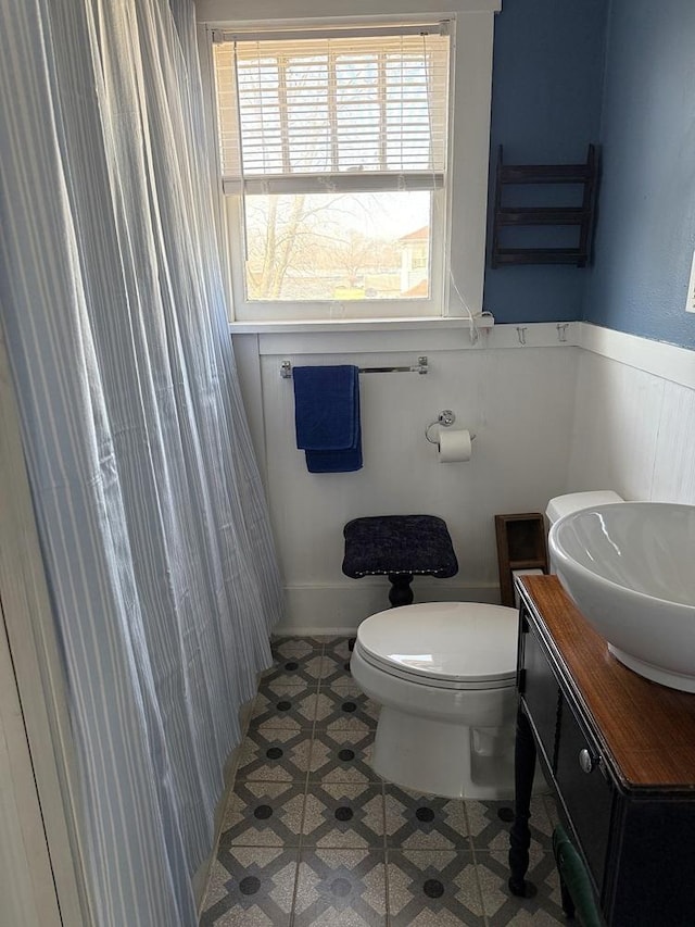 bathroom featuring vanity, tile patterned flooring, and toilet