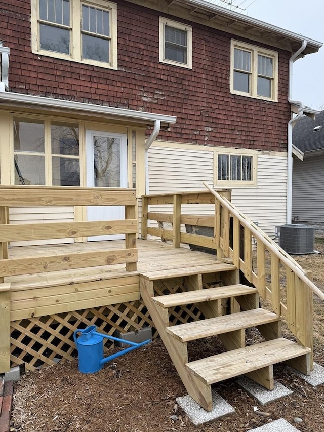 back of house with a wooden deck and cooling unit
