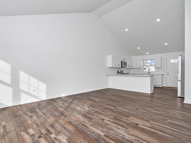 unfurnished living room with high vaulted ceiling, sink, and dark hardwood / wood-style flooring